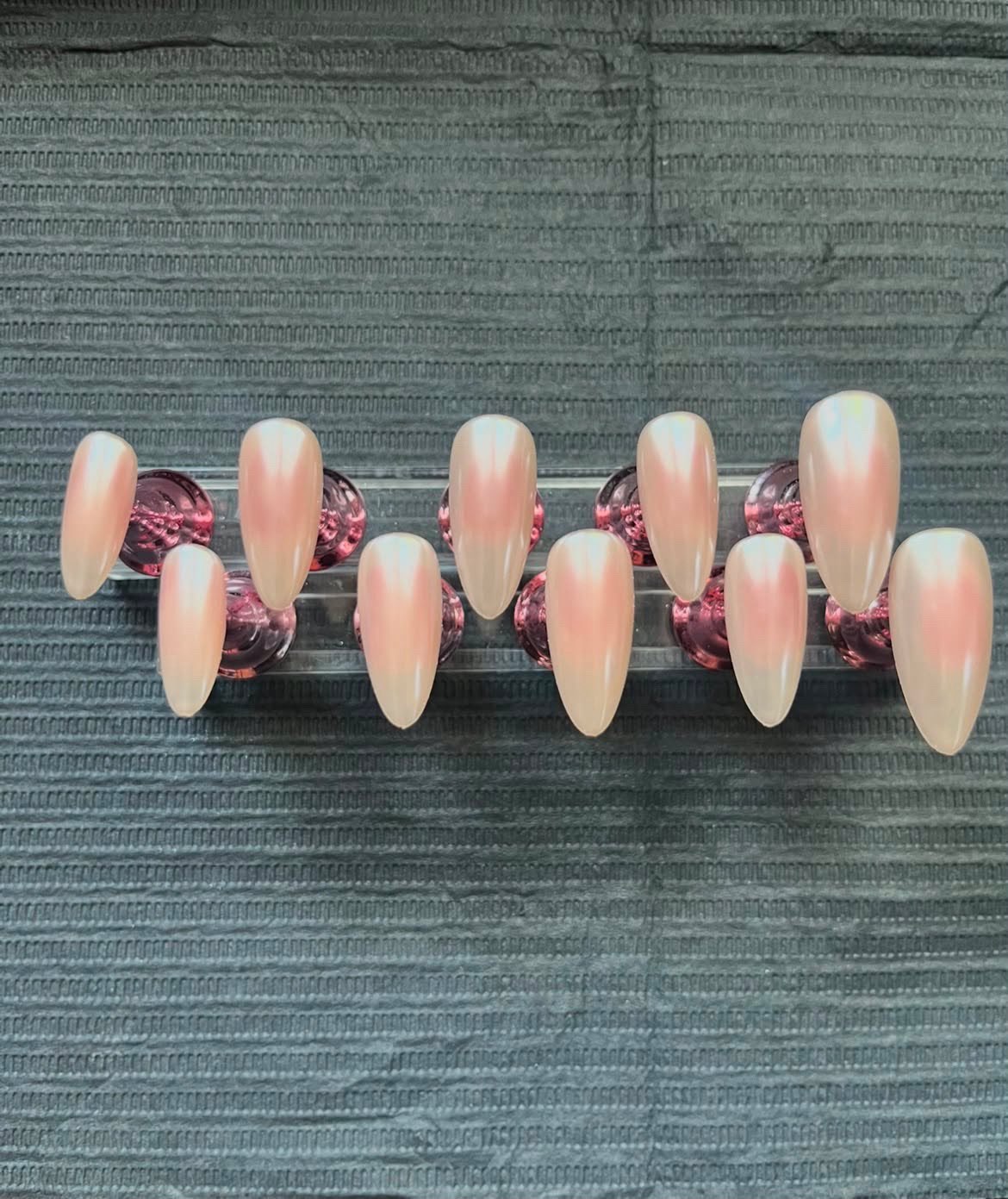 Pearlescent almond nails with iridescent finish
