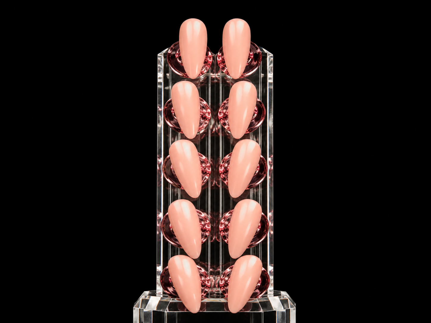 A full set of almond nails in soft rosé displayed on a crystal stand
